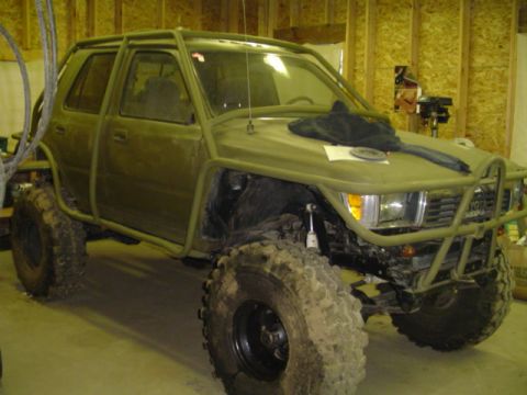 1993 Ford Bronco - This heavily modified SUV features a custom roll cage and oversized tires, suggesting it's built for off-road use.