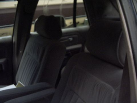 1990 Ford Crown Victoria LTD - Interior view of a car, showing gray fabric seats and armrests.