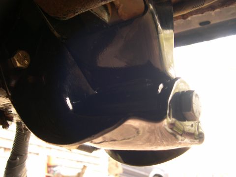 1994 Ford Bronco - A close-up view of a vehicle's suspension system component, likely recently painted.