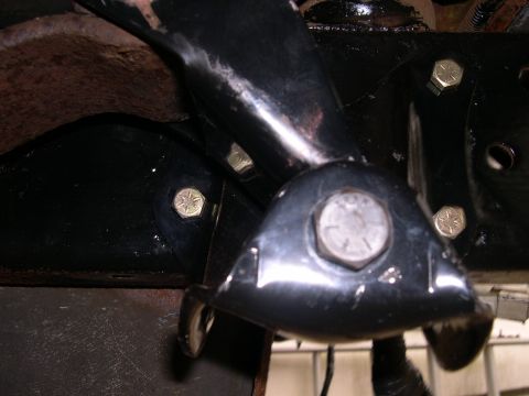 1994 Ford Bronco - Detail of vehicle frame components, showing bolted brackets and some surface rust.