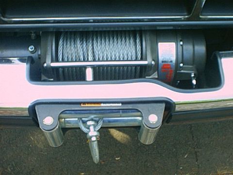 1995 Ford Bronco - A winch is mounted to the front bumper of a 1995 Ford Bronco, ready for off-road recovery.