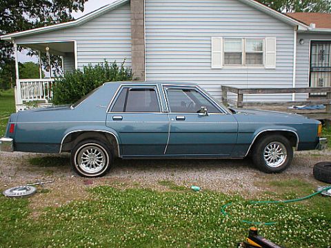 1987 Ford Crown Victoria LTD - This 1987 Ford Crown Victoria LTD is seen from the side in a residential setting.