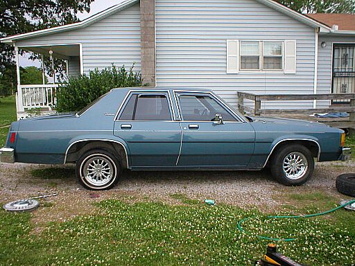 1987 Ford Crown Victoria LTD parked in gravel driveway, side view