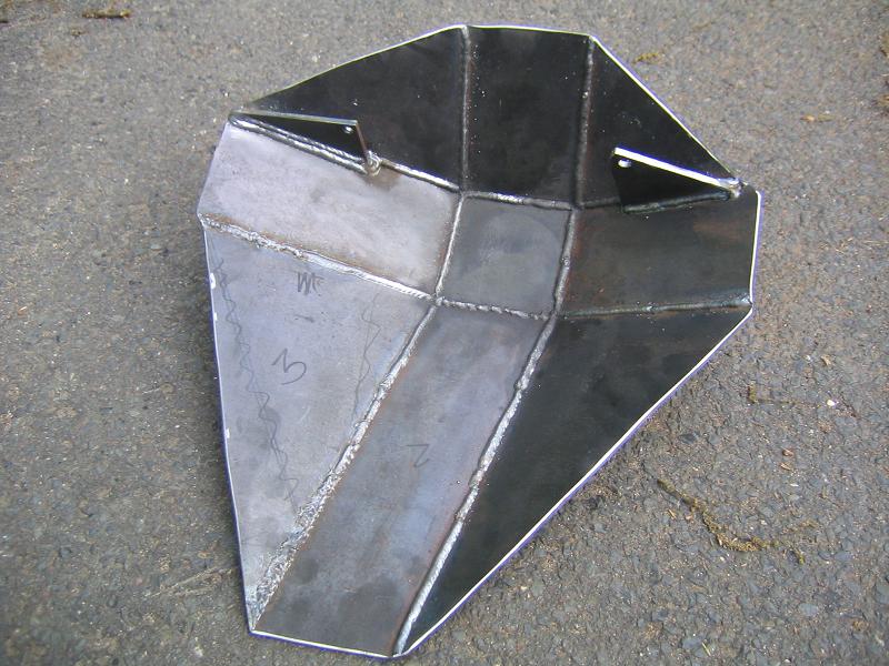 Metal skid plate with welded seams and etched numbers 'W', '3', and 'Z'