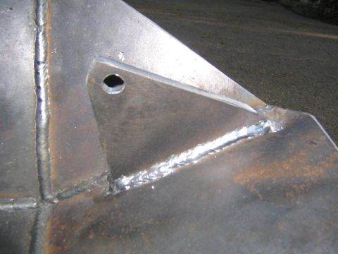 1978 Ford Bronco - Close-up of a welded metal component, likely a skid plate, showing fabrication details and a mounting hole.