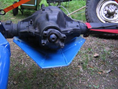 1978 Ford Bronco - A vehicle's rear axle and differential 'pumpkin' fitted with a blue steel differential skid-plate guard, the driveshaft yoke and axle tubes…