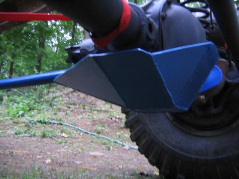1978 Ford Bronco - Low-angle close-up of a fabricated blue-painted differential skid plate welded around an axle housing, protecting the pumpkin from below. A…