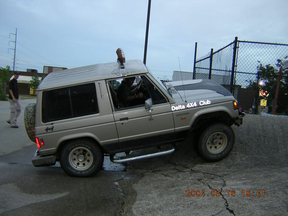 Mitsubishi Pajero/Montero with "Delta 4X4 Club" sticker on hood, driving on an incline