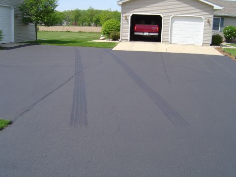 1978 Ford Bronco - Red pickup truck in garage with tire marks on the driveway.