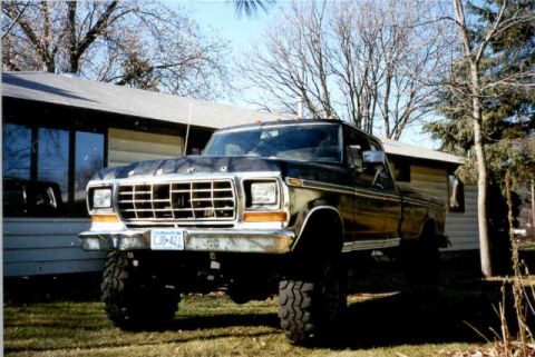 1978 Ford F-250 - This lifted 1978 Ford F-250 pickup truck is shown in a three-quarter front view, parked in front of a house.
