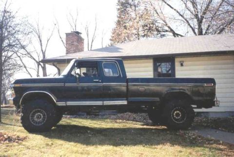 1978 Ford F-250 - Side view of a dark blue 1978 Ford F-250 pickup truck with large tires.