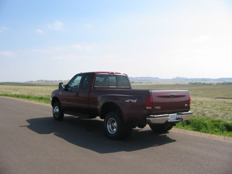 2000 Ford F-350 - Rear view of a maroon 2000 Ford F-350 Super Duty pickup truck on a paved road.