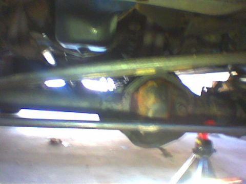 1979 Ford Bronco - A view of the underside of a vehicle, focusing on the differential and suspension system, with a "SUPERMOTORS.NET" watermark visible.