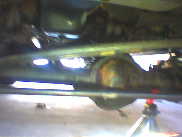 Undercarriage view of vehicle differential and suspension components