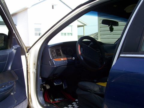 1995 Ford Crown Victoria - The interior of a 1995 Ford Crown Victoria is shown with the driver's door open.