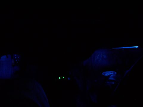 1995 Ford Crown Victoria - A blue Ford emblem is visible on a dark surface, with some green lights in the background.