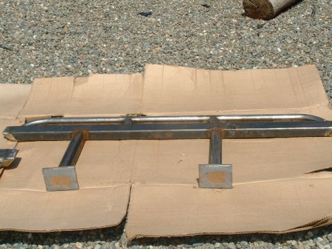 1991 Ford Bronco - Metal slider bars with square mounting brackets are shown on cardboard.
