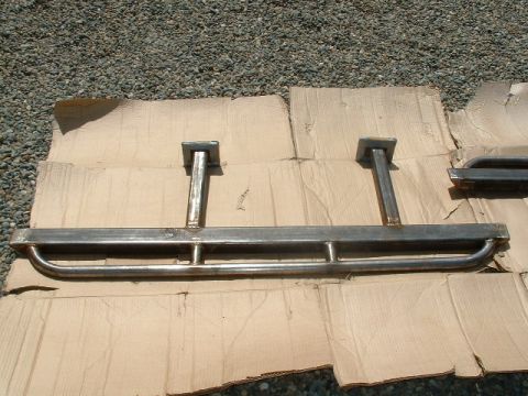 1991 Ford Bronco - Custom metal sliders are shown laid out on cardboard, ready for installation.