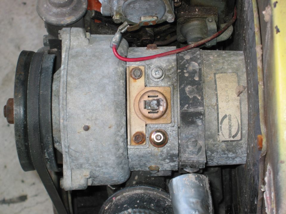 Close-up of a remanufactured alternator with a red wire connected
