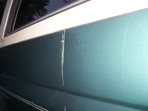 1989 Ford Bronco - This photo shows a damaged section of a vehicle's exterior panel.