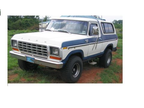 1978 Ford Bronco - This 1978 Ford Bronco features a two-tone white and blue paint scheme with a prominent blue stripe.