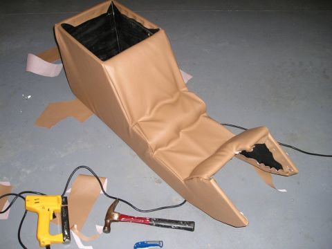 1996 Ford Bronco - A custom center console is being upholstered with tan material, with tools laid out on the floor.