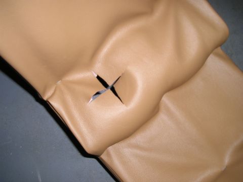 1996 Ford Bronco - A tan leather console part shows an X-shaped cut, with a Supermotors.net logo visible.