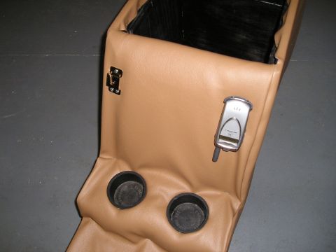 1996 Ford Bronco - A tan leather custom center console with two cup holders and a flip phone is shown.