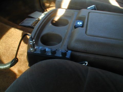 1988 Ford Bronco - Interior shot of a vehicle's center console, showing a CB radio and cup holders.