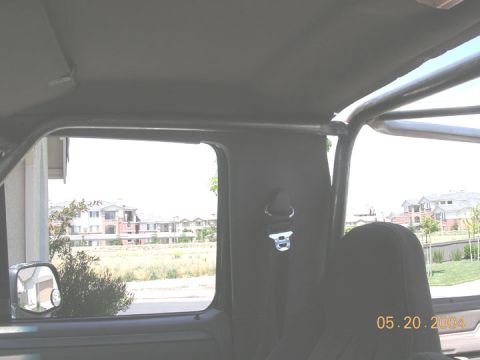 1994 Ford Bronco - The interior of a vehicle shows a roll cage and a seatbelt, with a date stamp of 05.20.2004.