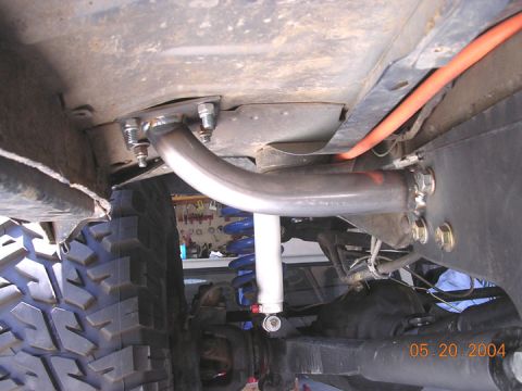 1994 Ford Bronco - Custom roll cage tubing is visible under the vehicle, along with suspension components and a tire. The date 05.20.2004 is stamped on the im…
