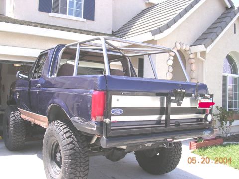 1994 Ford Bronco - This 1994 Ford Bronco has a custom roll cage and is parked in a driveway.