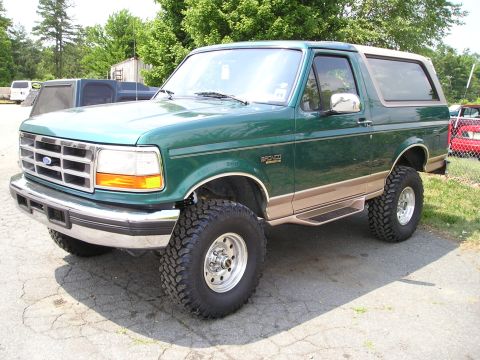 1996 Ford Bronco - This lifted 1996 Ford Bronco is shown from a three-quarter front angle on a paved surface.