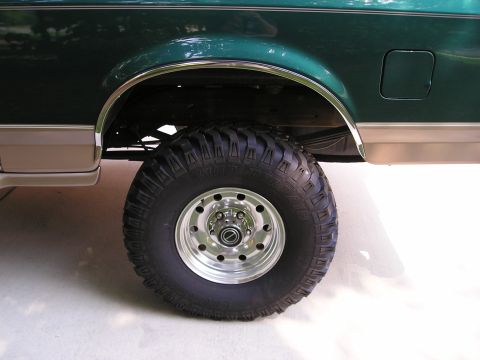 1996 Ford Bronco - Close-up of a lifted 1992 Ford Bronco's rear wheel and fender area.