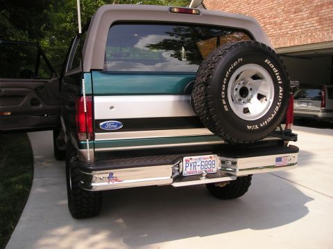 1996 Ford Bronco - This 1996 Ford Bronco is parked in a driveway with its rear facing the camera. A spare tire is mounted on the tailgate.