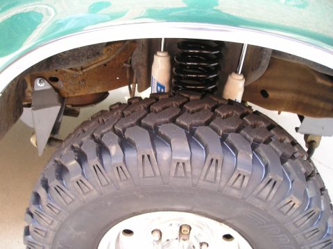 1996 Ford Bronco - Close-up of the suspension and tire on a lifted 1996 Ford Bronco.