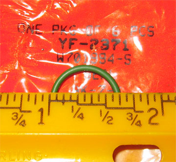 1996 Ford Crown Victoria - A green o-ring is shown with a ruler for scale. Text on packaging is visible.