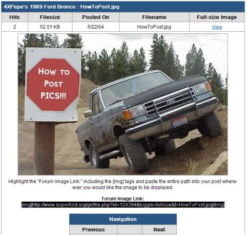 1989 Ford Bronco - A dirty Ford pickup truck is shown at an angle on a dirt slope, with a sign nearby.