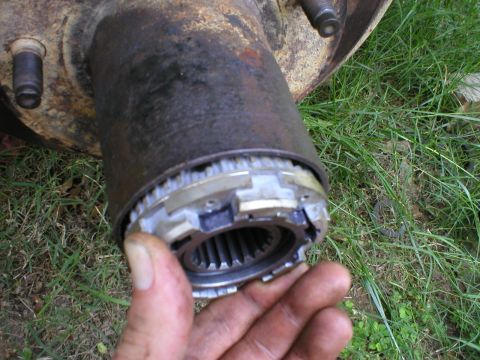 1986 Ford Bronco - Close-up view of a manual locking hub mechanism, showing the splined shaft and engagement components.