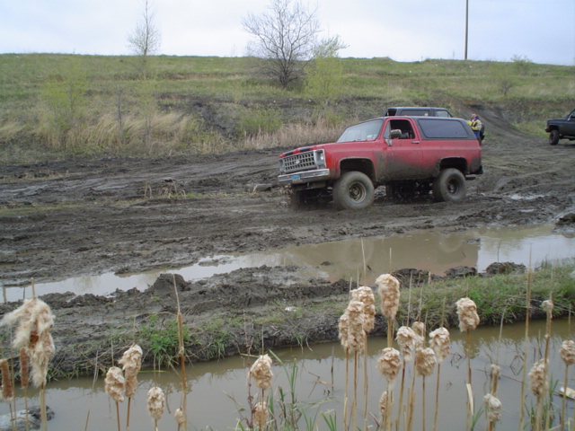 Red SUV driving through mud. 1973-1991 Chevrolet K5 Blazer