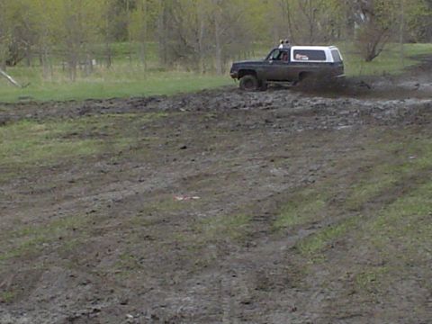 1981 Ford Bronco - This 1981 Ford Bronco navigates a muddy terrain, kicking up dirt as it goes.
