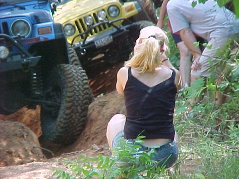 1978 Ford Bronco - Two Jeep Wranglers navigate a challenging off-road trail while onlookers observe the action.