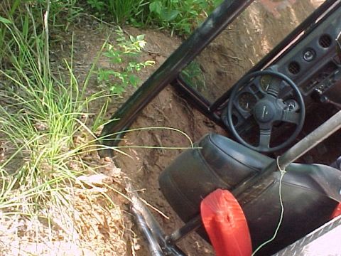 1978 Ford Bronco - The interior of an off-road vehicle is visible as it is stuck in a dirt embankment.
