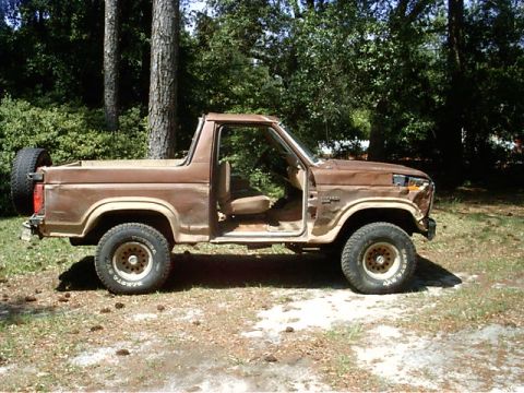 1985 Ford Bronco - This 1980s Ford Bronco, likely from the early 1980s, is seen with its doors removed and a spare tire mounted on the back.