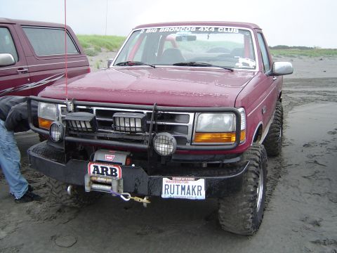 1989 Ford Bronco - This modified Ford Bronco is equipped for off-road adventures on a sandy beach, with a winch and extra lights.