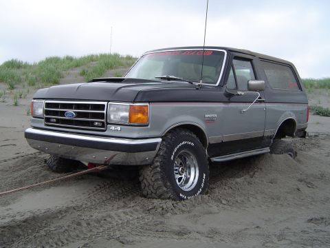 1989 Ford Bronco - This 1989 Ford Bronco is stuck in the sand, showing its 4x4 capabilities.