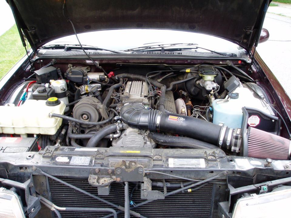 Engine bay with aftermarket K&N cone intake filter and black intake tubing