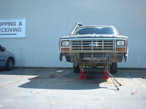 1983 Ford Bronco - Ford truck on jack stands with snorkel installed, front bumper removed for work.
