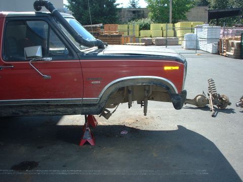1983 Ford Bronco - This red Ford Bronco is up on jack stands with its front axle removed, and a snorkel installed.