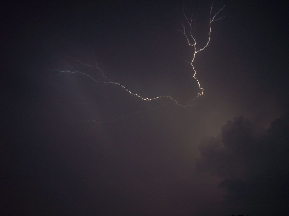 Lightning strike over dark clouds with Supermotors logo